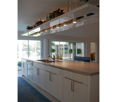 KITCHEN OVERLOOKING THE POOL AND LAKEFRONT BEYOND